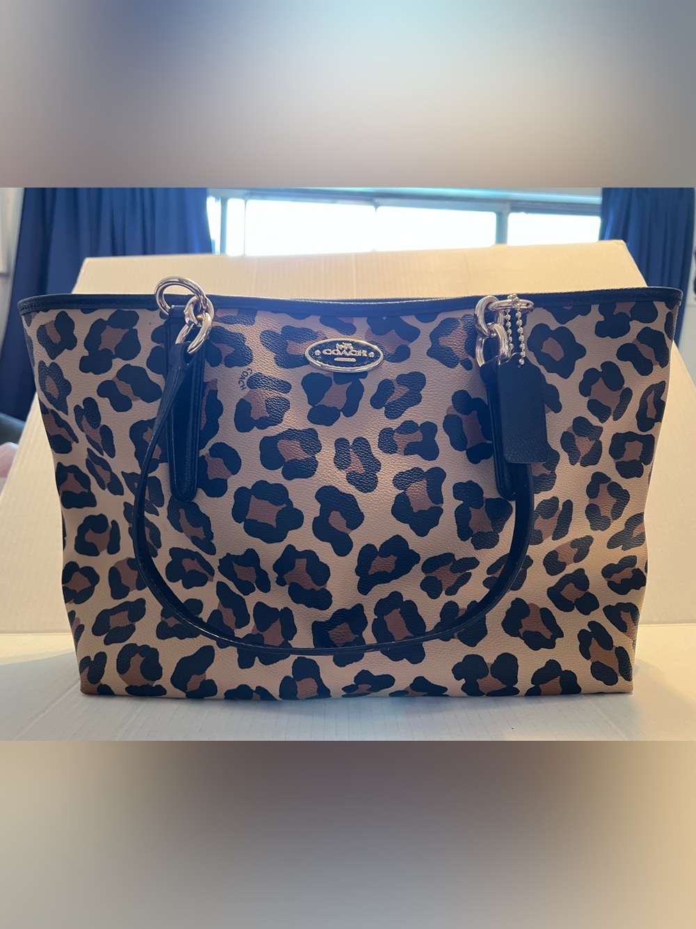 Coach 🐆 leopard print tote bag with gold tone hardware and black trim & handles